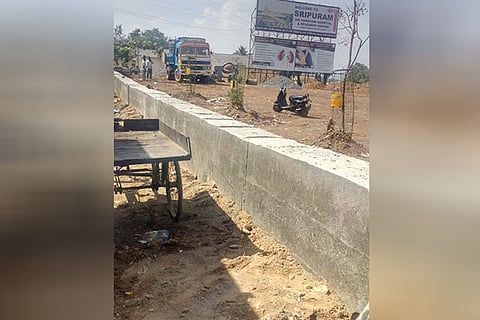 The four-ft-high wall being built by the Highways Dep, blocking access to 73 cents of private land inside