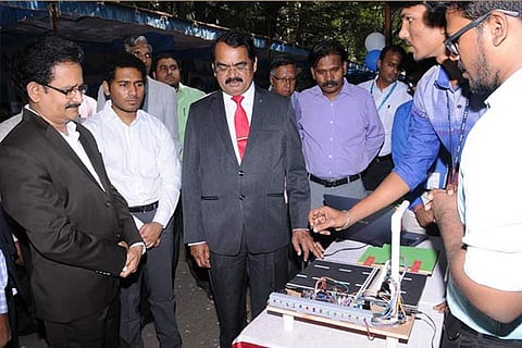 A student displays a model, he designed to the chief guest at the event