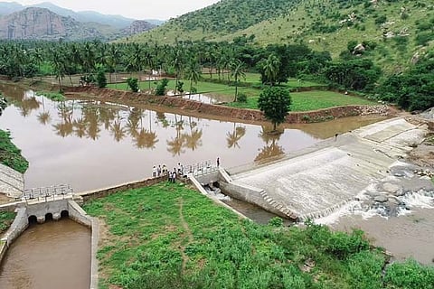 Officials inspect a water-filled check dam in Tiruvannamalai