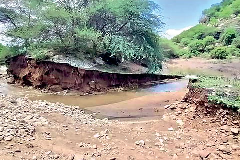Water flowing out of an irrigation tank that suffered a breach near Ponnapalli village in Ambur