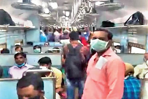 Passengers standing closely together inside the special train