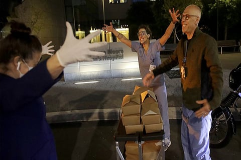 Nightbird Restaurant chef and owner Kim Alter, left, mimics giving a hug to nurse practitioner