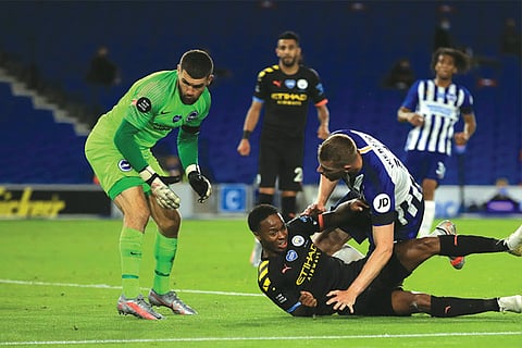 Raheem Sterling (on the floor) bundles in his third goal