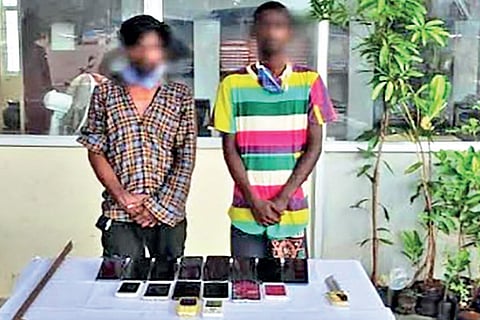 Jayaraj and Raja with the seized mobile phones
