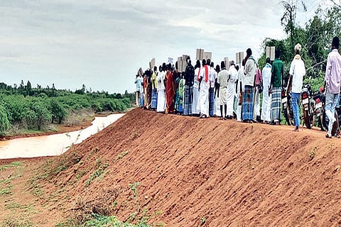 Farmers in Thanjavur staging a protest on a lake bund on Tuesday
