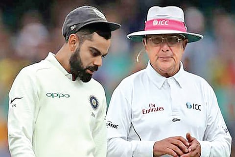Virat Kohli (left) and umpire Ian Gould