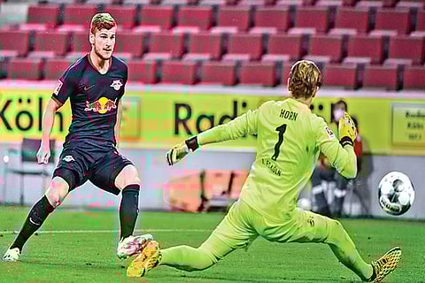 RB Leipzig striker Timo Werner puts the ball past Cologne goalkeeper Timo Horn