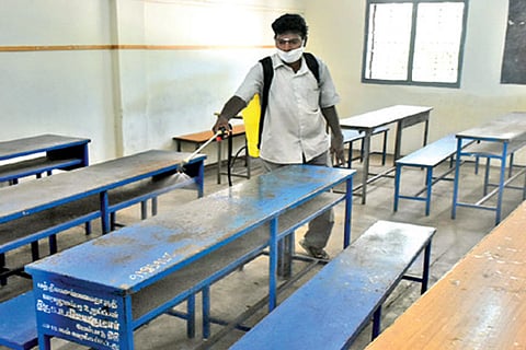 A classroom in a class 10 exam centre being sanitised in Chennai on Thursday
