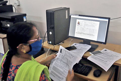 A teacher at a city school downloads hall tickets for SSLC exams, which would commence on June 15