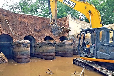 The damaged retention walls of Peruvalai irrigation canal in Tiruchy being repaired