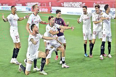Sevilla players celebrate defeating derby rival Real Betis