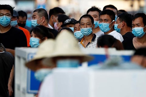 Beijing district in 'wartime emergency' after virus spike shuts market