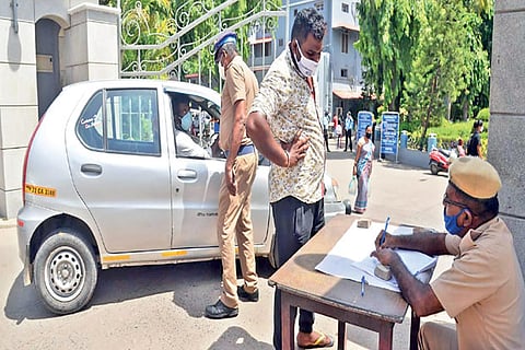 Police checking a car for e-pass at CMC Hospital entrance