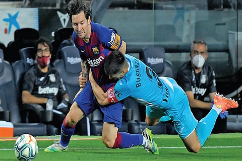 Barcelona?s Lionel Messi (left) tries to get past a Leganes defender in a La Liga match