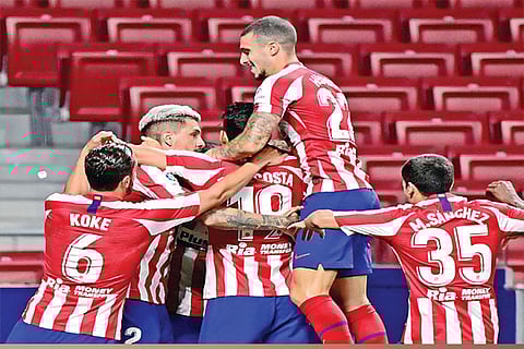 Atletico Madrid players celebrate the winning goal