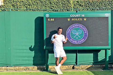 Leander Paes poses on Court 16 of Wimbledon in London