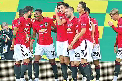 United?s Harry Maguire is congratulated after scoring a last-gasp goal