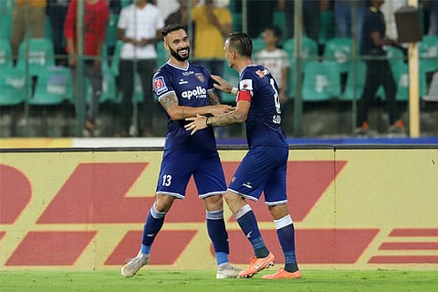 Chennaiyin FC?s defender Eli Sabia (left) celebrates after scoring a goal with captain Lucian Goian