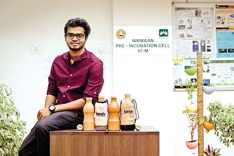 Sandeep Kumar Gangaram with the clay watter bottles he designed