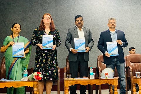 Guest professor Andrea and other dignitaries with the booklet for students at the national conference