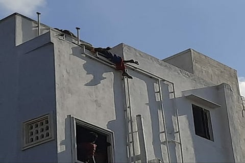 The woman stood on the edge of terrace, threatening to jump off