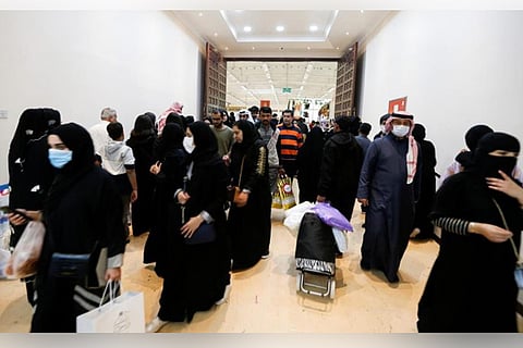 File photo: Locals wear face masks to take precautions , as they shop at Manama (Reuters)
