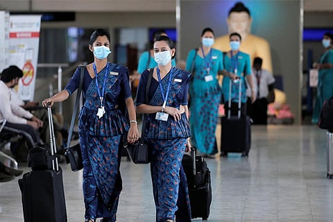 Sri Lankan Airlines staff wear masks at Bandaranaike International Airport, Sri Lanka (Reuters)