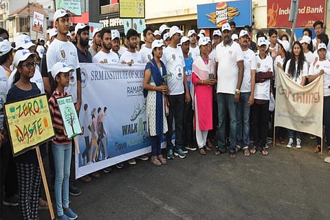 Participants holding placards at the walkathon on Elliots Beach