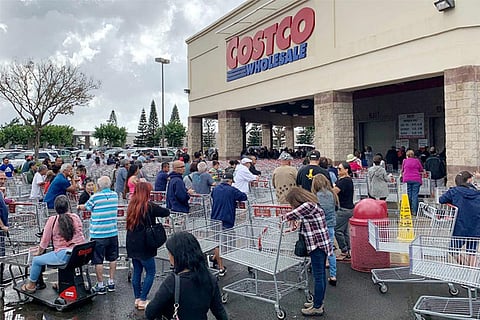 Shoppers line up to buy supplies to stock up 14-day food, water etc (File photo: Reuters)