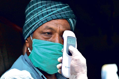 A lorry driver takes a fever test