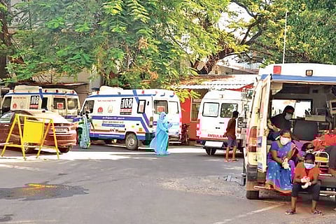 Patients wait inside ambulances outside KMCH.