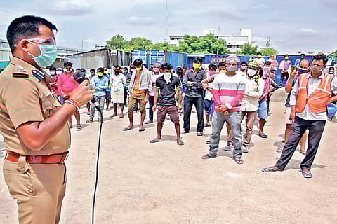 Vellore SP Pravesh Kumar addressing migrant workers in Vellore on Monday