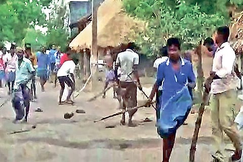 People armed with sticks at Dharmanallur village near Kammapuram in Cuddalore district
