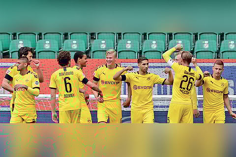 Borussia Dortmund players celebrate the first goal