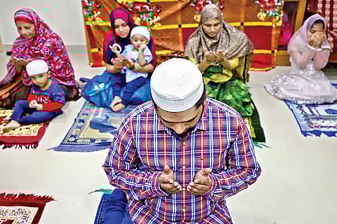 A man during Ramzan namaz at his house