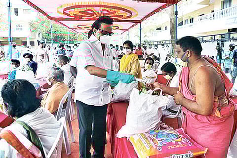 DMK president handing over COVID-19 relief materials to priests, college students and women