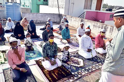 A Muslim family prays on their terrace due to the lockdown in Coimbatore on Monday