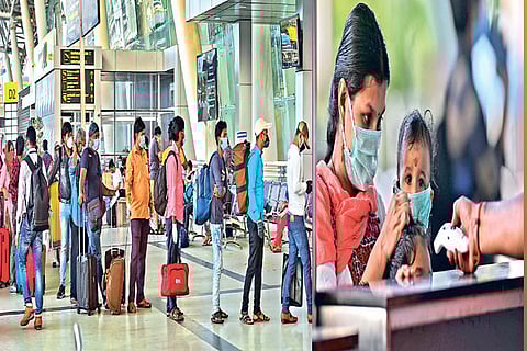 Passengers waiting to show tickets and enter the airport; staff checking temperature of passengers