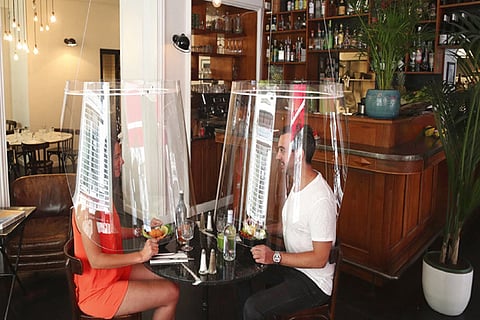 lampshade-like plastic shields to protect diners from the virus