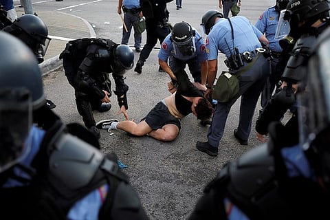 Police in riot gear detain a protester in Raleigh, North Carolina