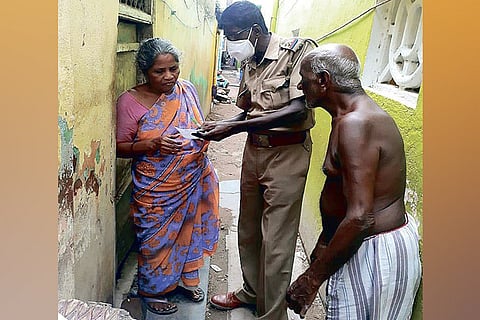 A policeman helping the elderly couple after they complained against their son