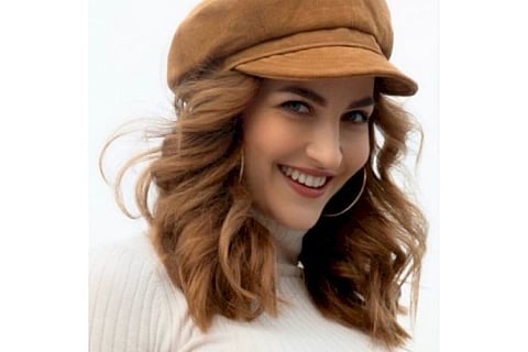 Elli AvrRam paints the town copper red