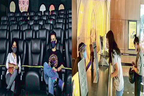 Audiences maintain social distancing at a cinema hall on Tuesday; A small queue for tickets