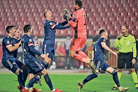 Scotland players jump in joy after qualifying for the European Championship via play-offs