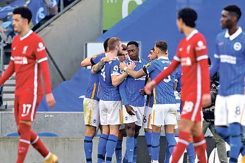 Brighton players celebrate after scoring the equaliser