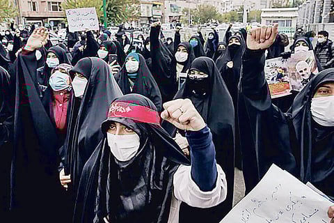 Protesters demonstrating against the killing of a top Iranian nuclear scientist in Tehran, Iran