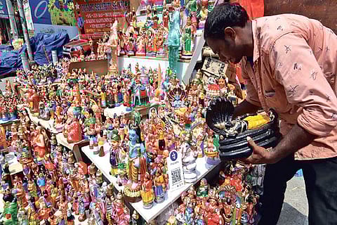 A vendor arranges idols during the ongoing festive season near Mylapore Tank on Friday