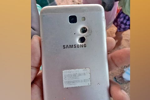 Holes caused by pellets on the mobile phone