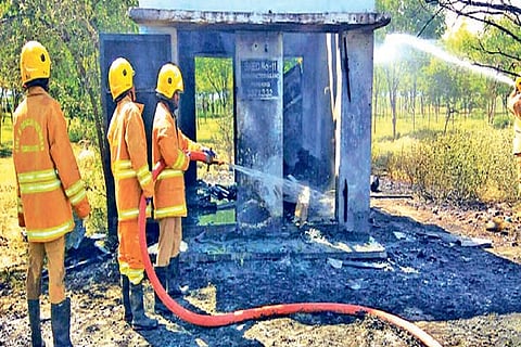 Firefighters douse the fire on Friday
