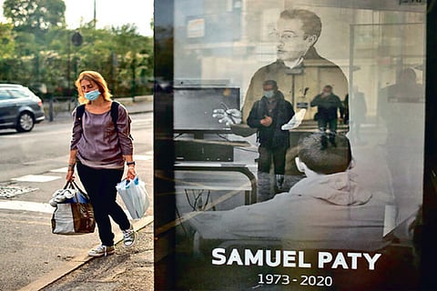 A portrait of Mr. Paty at a bus stop in Conflans-Sainte-Honorine